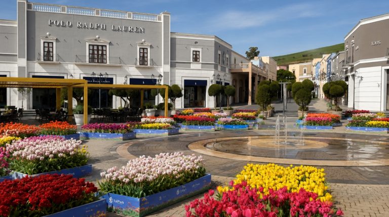 Colorful tulip displays by TuliPark in the central square of Sicilia Outlet Village during a spring floral event.